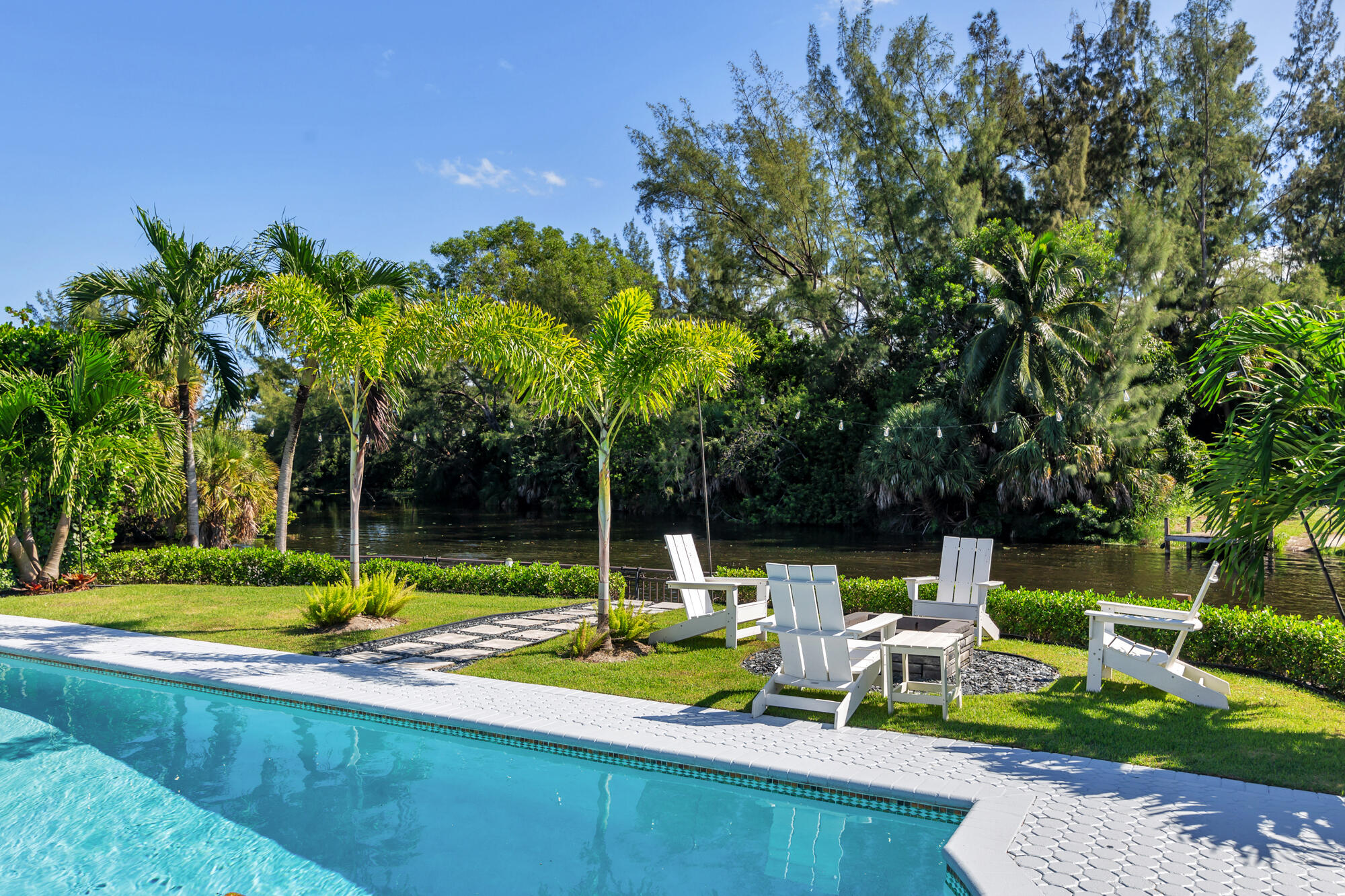 7730 Beta Circle Lake Clarke Shores, FL 33406 - Photo 16 of 50 a view of a fountain with a backyard of the house