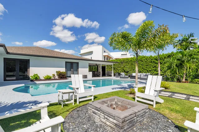 a view of a house with backyard porch and sitting area