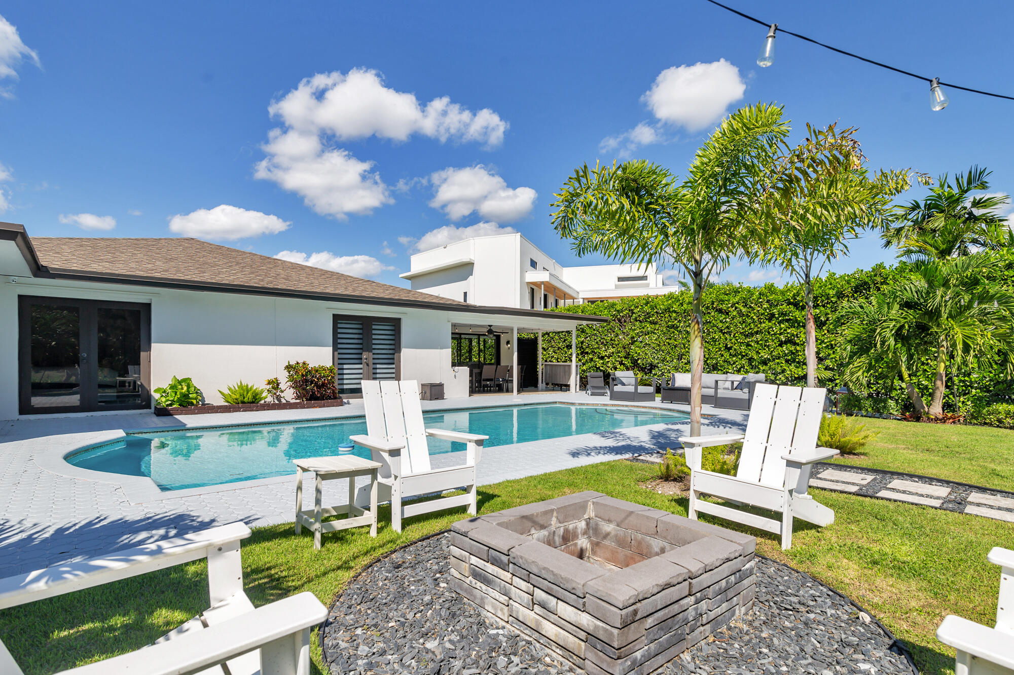 7730 Beta Circle Lake Clarke Shores, FL 33406 - Photo 18 of 50 a view of a house with backyard porch and sitting area