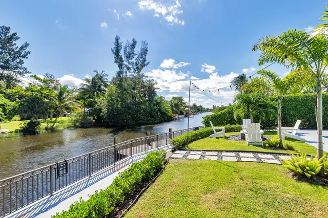 a view of a house with swimming pool and sitting area