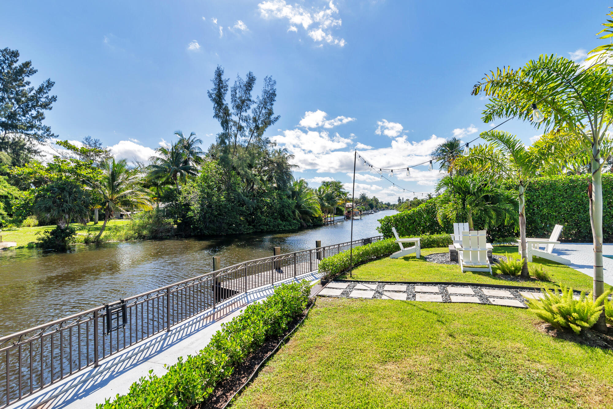 7730 Beta Circle Lake Clarke Shores, FL 33406 - Photo 20 of 50 a view of a house with swimming pool and sitting area
