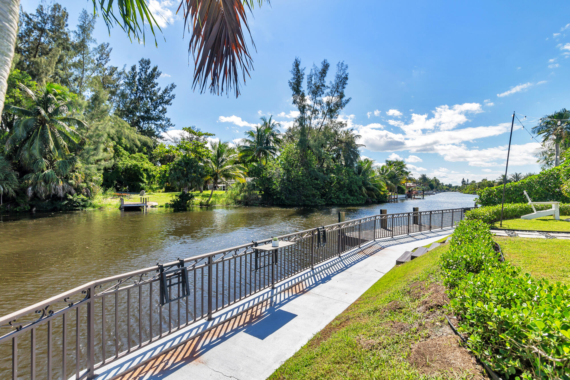 7730 Beta Circle Lake Clarke Shores, FL 33406 - Photo 21 of 50 a view of a swimming pool with a lake view