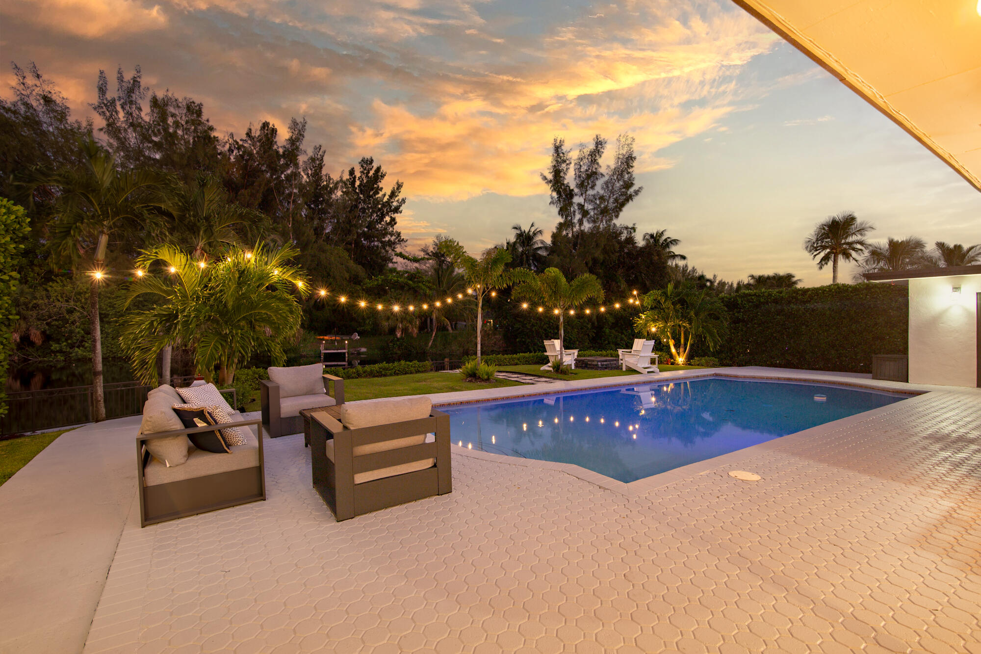 7730 Beta Circle Lake Clarke Shores, FL 33406 - Photo 22 of 50 a view of outdoor space with swimming pool and couches