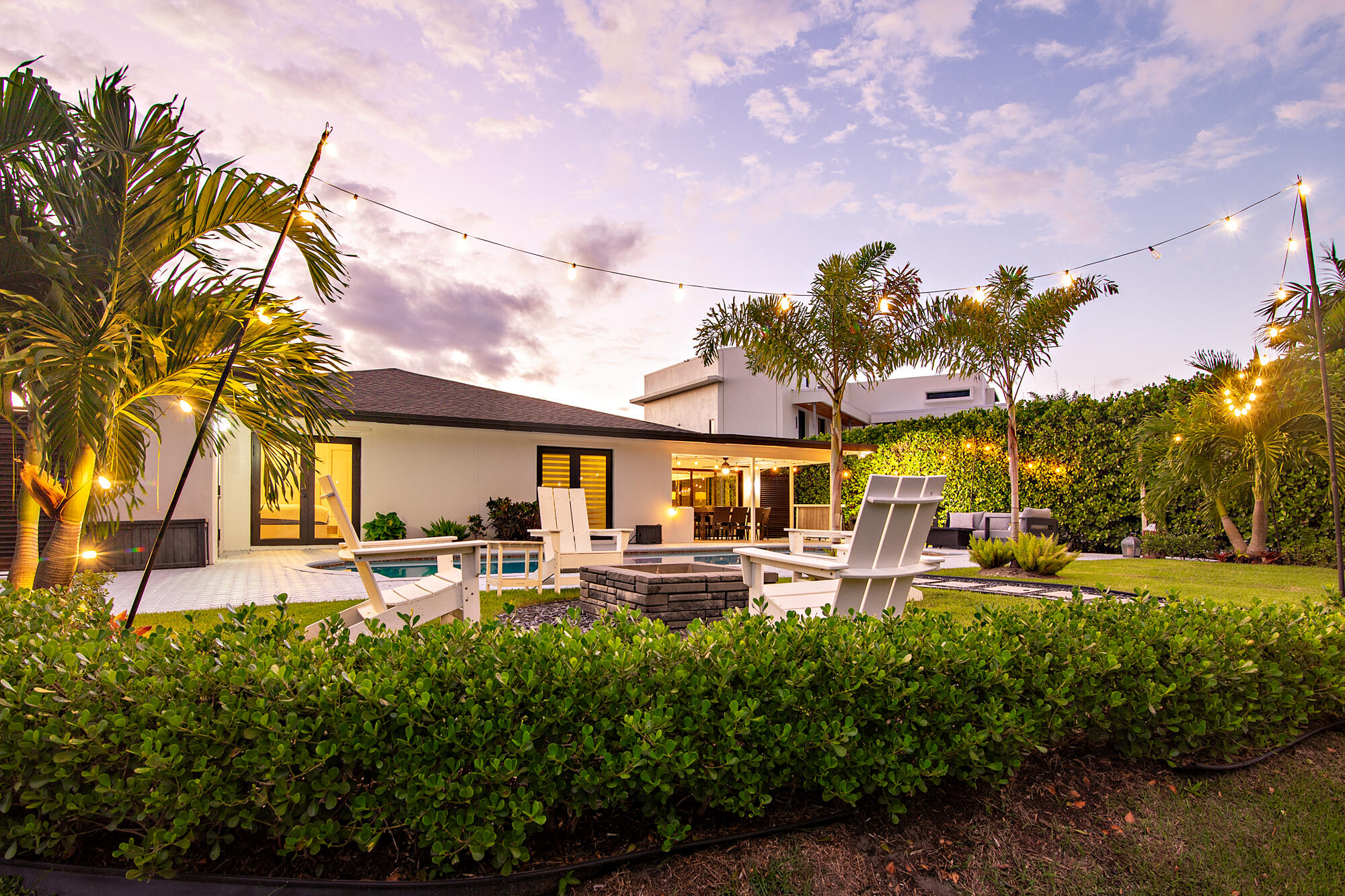 7730 Beta Circle Lake Clarke Shores, FL 33406 - Photo 27 of 50 a front view of a house with garden and trees