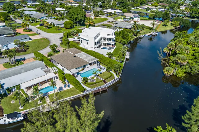 an aerial view of residential houses with outdoor space and swimming pool
