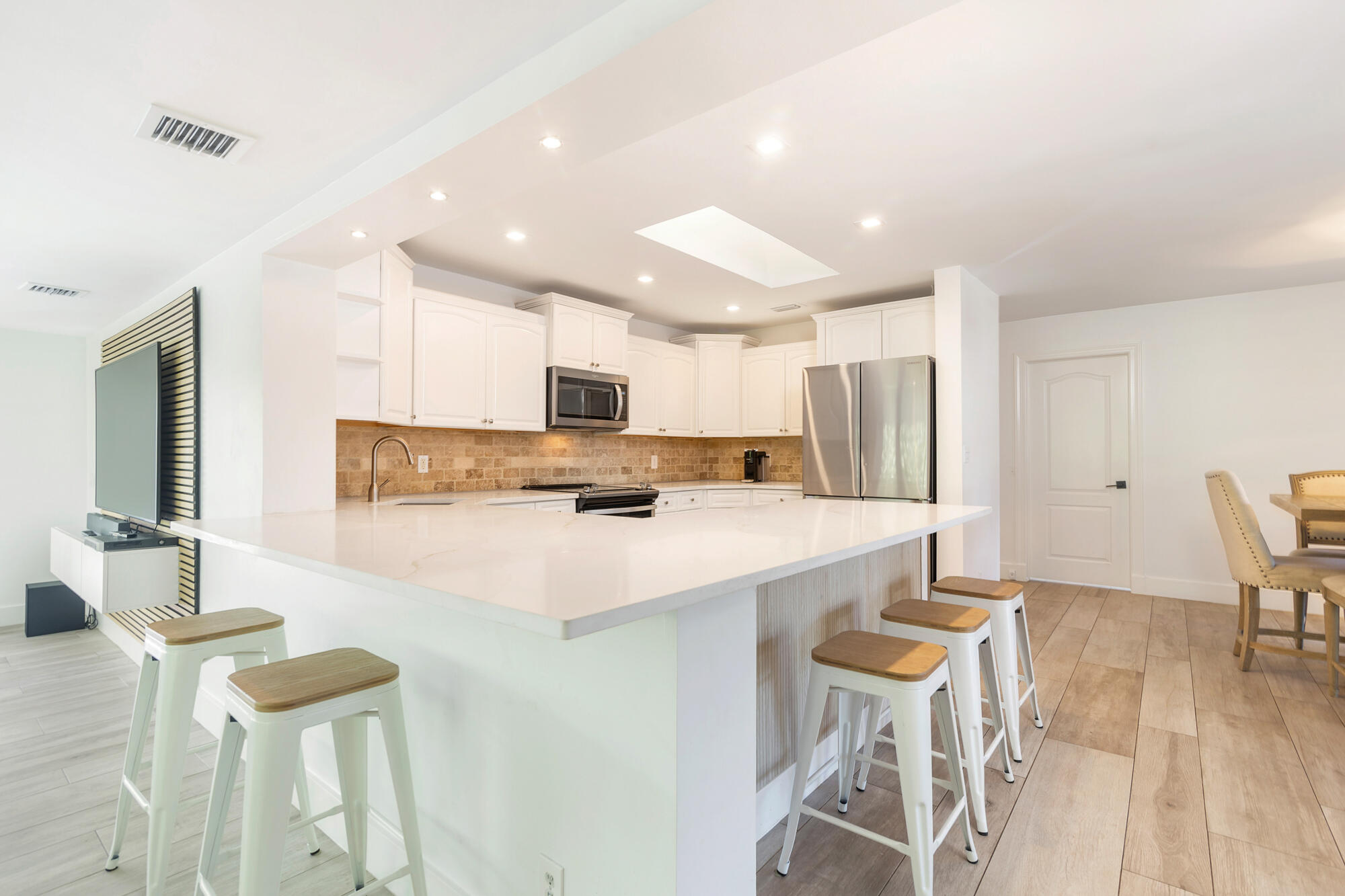 7730 Beta Circle Lake Clarke Shores, FL 33406 - Photo 33 of 50 a large kitchen with a table and chairs