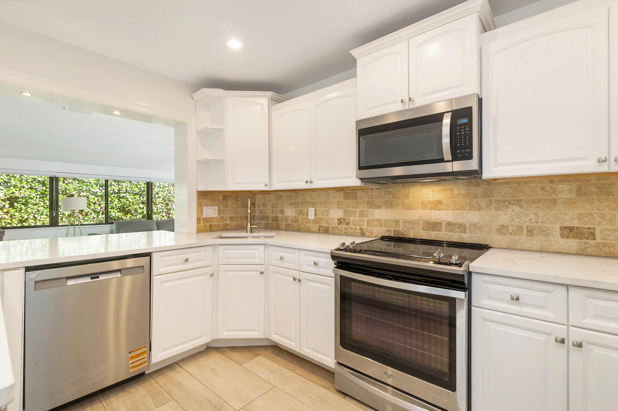 7730 Beta Circle Lake Clarke Shores, FL 33406 - Photo 34 of 50 a kitchen with cabinets stainless steel appliances and a sink