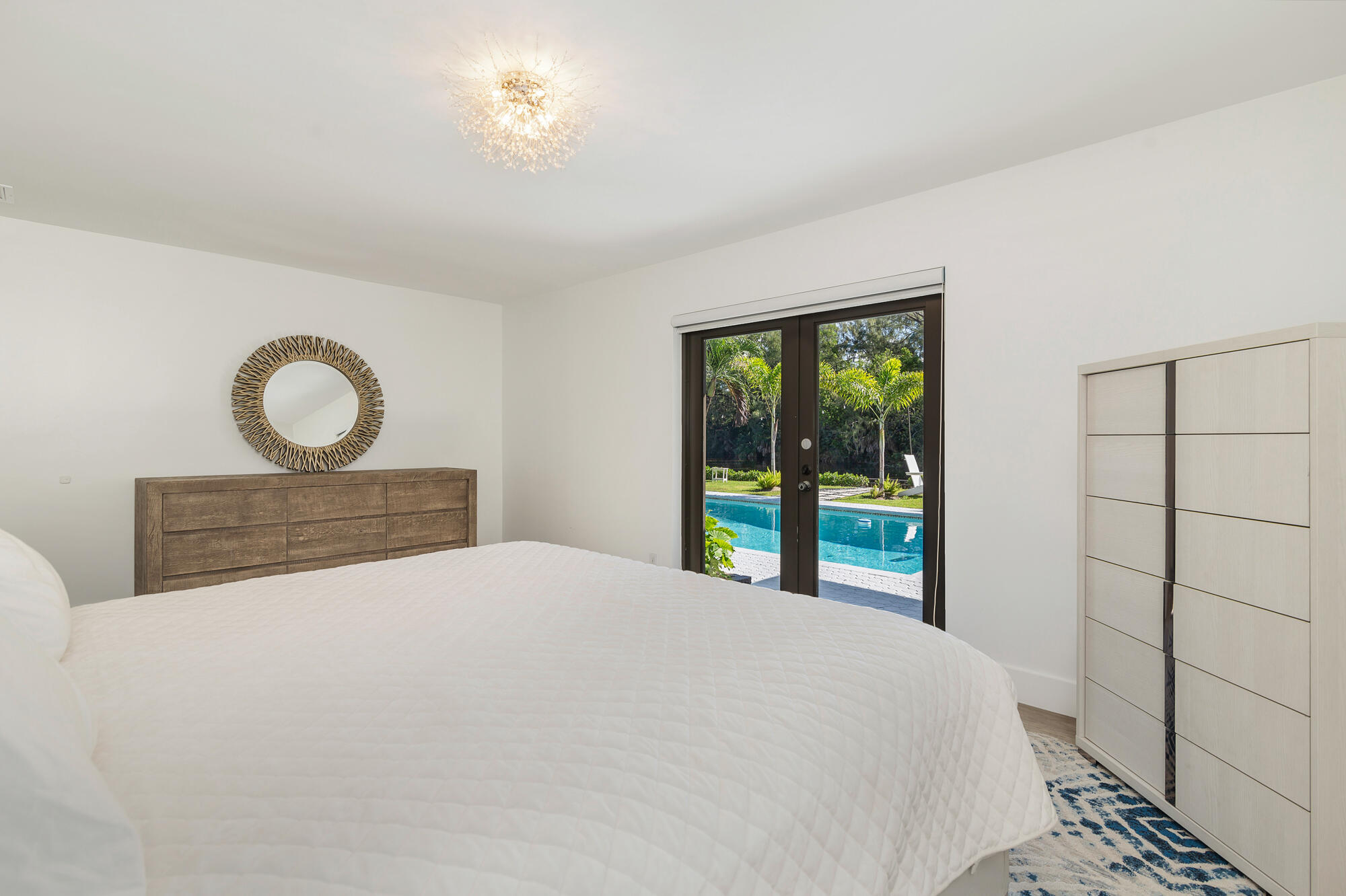 7730 Beta Circle Lake Clarke Shores, FL 33406 - Photo 40 of 50 a bedroom with a bed and a window