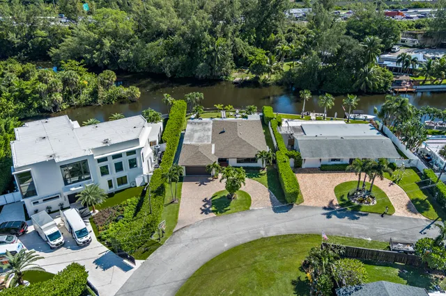 an aerial view of a house with garden space and street view