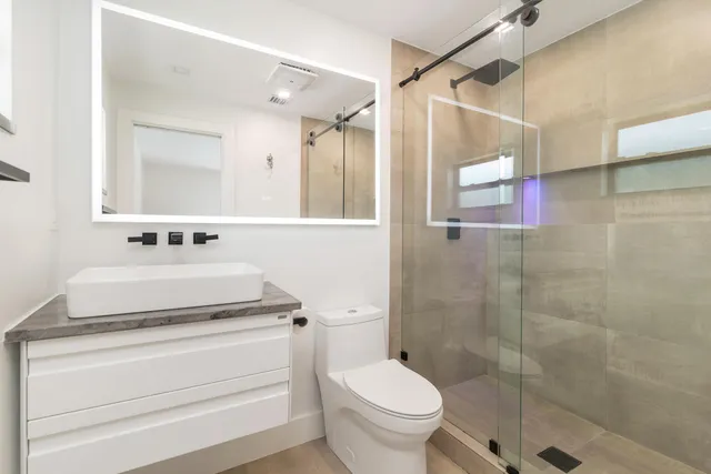 a spacious bedroom with a bed and a window