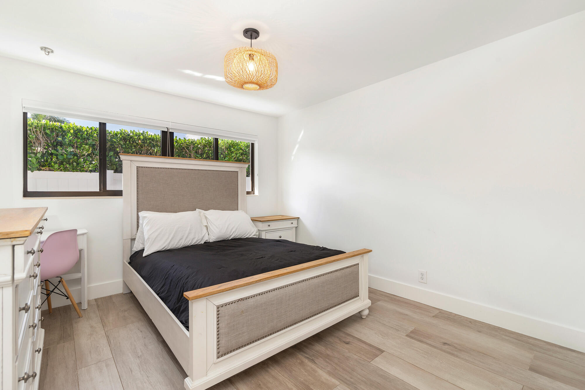 7730 Beta Circle Lake Clarke Shores, FL 33406 - Photo 44 of 50 a bed sitting in a bedroom next to a window