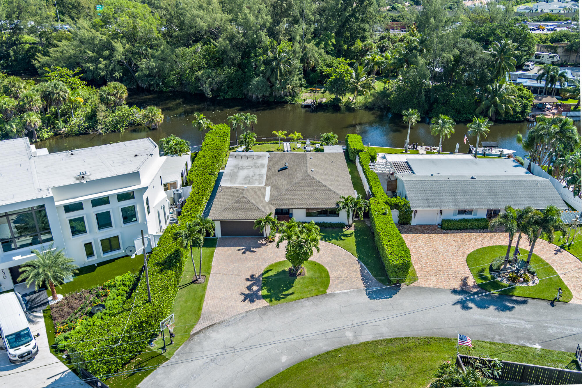 7730 Beta Circle Lake Clarke Shores, FL 33406 - Photo 49 of 50 an aerial view of a house with a garden and lake view