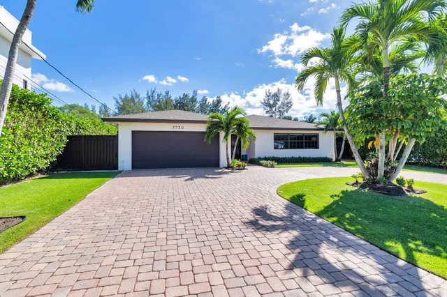a front view of a house with a garden and a yard