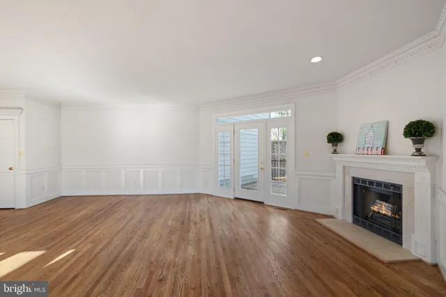 a view of empty room with wooden floor and fireplace