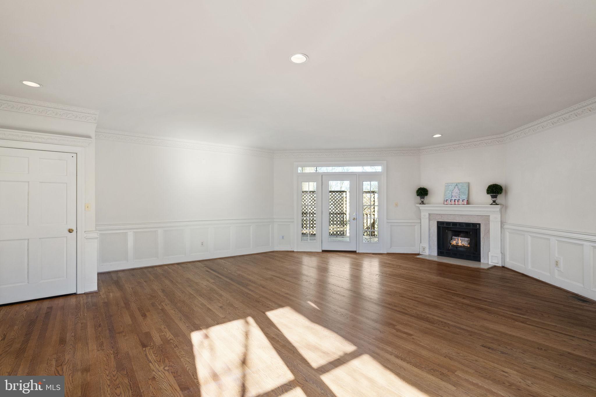 1537 Cedar Avenue McLean, VA 22101 - Photo 15 of 54 wooden floor fireplace and windows in an empty room