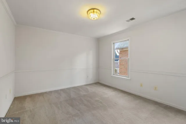 a view of an empty room and a window