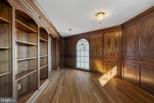 an empty room with a empty space and windows