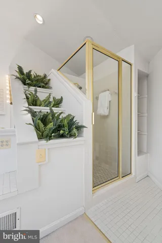 a bathroom with a double vanity sink a mirror and shower