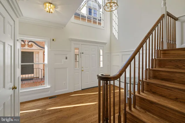 a view of an entryway with wooden floor and door