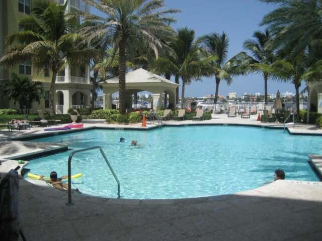 802 West Windward Way, Unit 211 Lantana, FL 33462 - Photo 16 of 32 a view of swimming pool with outdoor seating and lake view