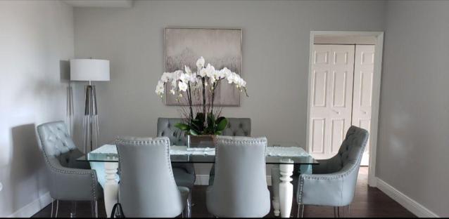 802 West Windward Way, Unit 211 Lantana, FL 33462 - Photo 24 of 32 a view of a dining room with furniture a chandelier and wooden floor