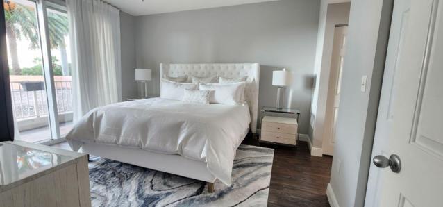 802 West Windward Way, Unit 211 Lantana, FL 33462 - Photo 26 of 32 a bed sitting in a bedroom next to a window