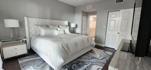 a living room with furniture and a floor to ceiling window