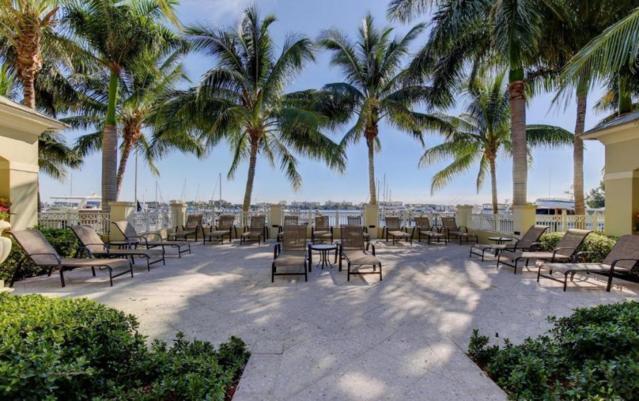 802 West Windward Way, Unit 211 Lantana, FL 33462 - Photo 5 of 32 a row of palm trees sitting in a backyard of a house