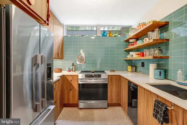 a kitchen with stainless steel appliances granite countertop a refrigerator and a stove