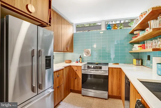 a kitchen with a stove top oven and refrigerator