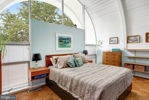 a bedroom with a bed and a window