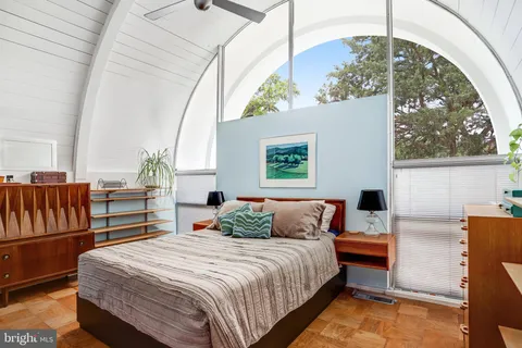 a bedroom with a bed and window