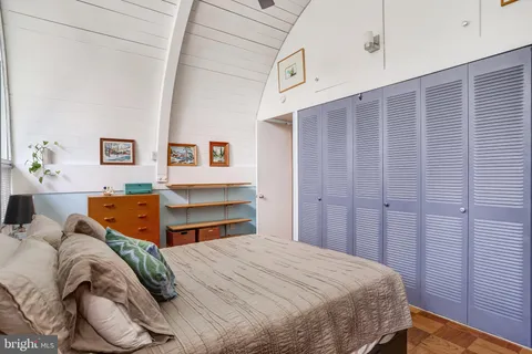 a bedroom with a bed and a lamp