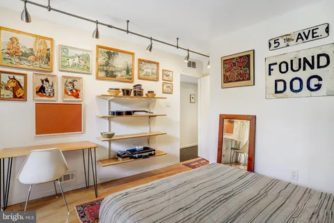 a bedroom with a bed and a chair in it