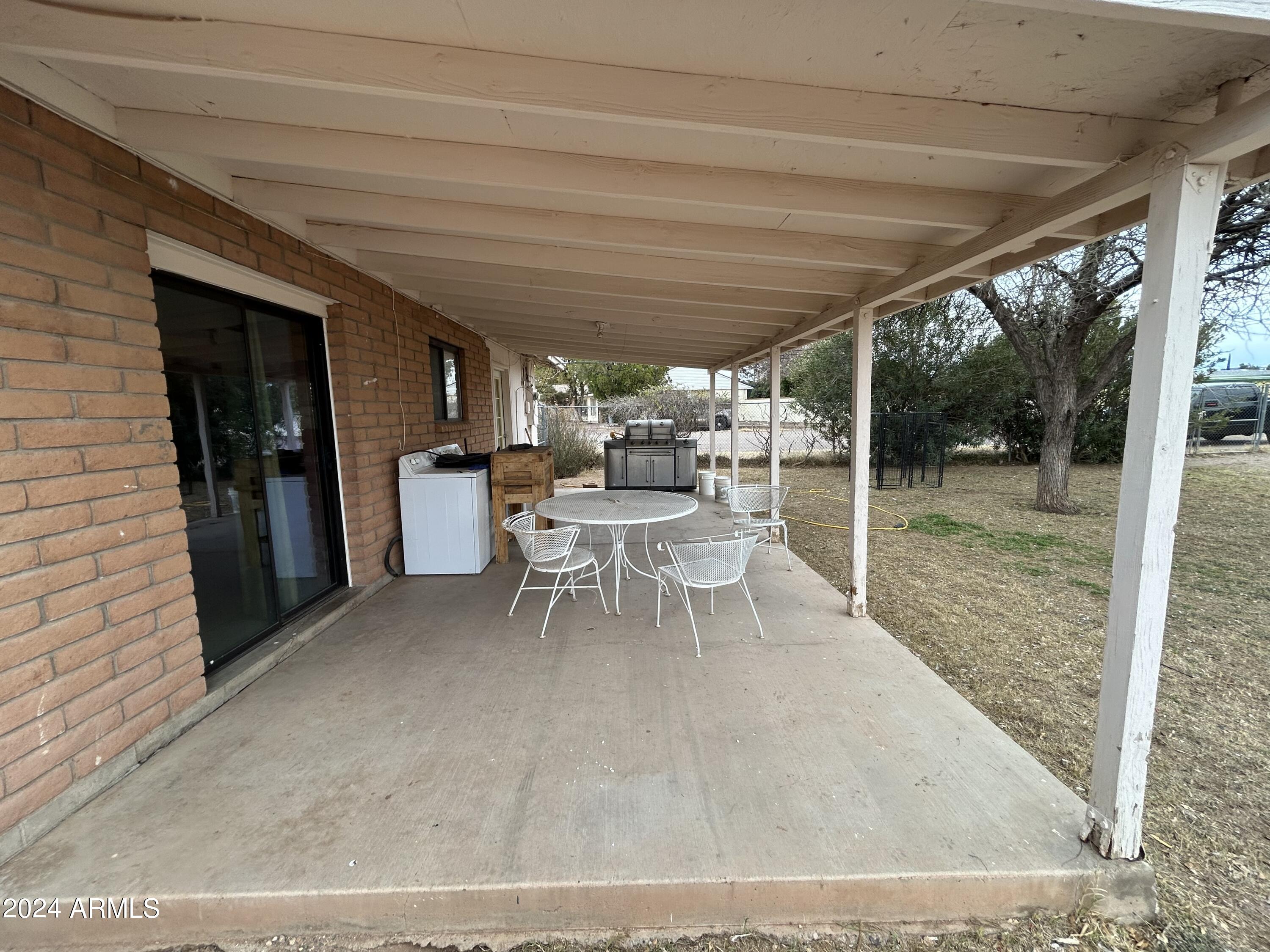 2419 East 10th Street Douglas, AZ 85607 - Photo 13 of 21 a dining room with furniture and a garden view