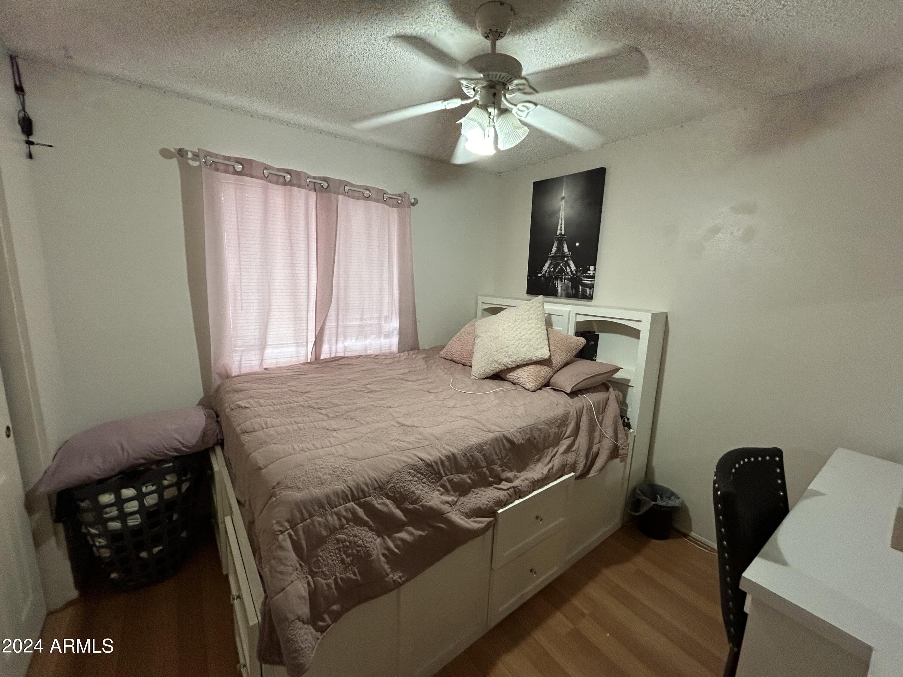 2419 East 10th Street Douglas, AZ 85607 - Photo 15 of 21 a bedroom with a bed mirror and window