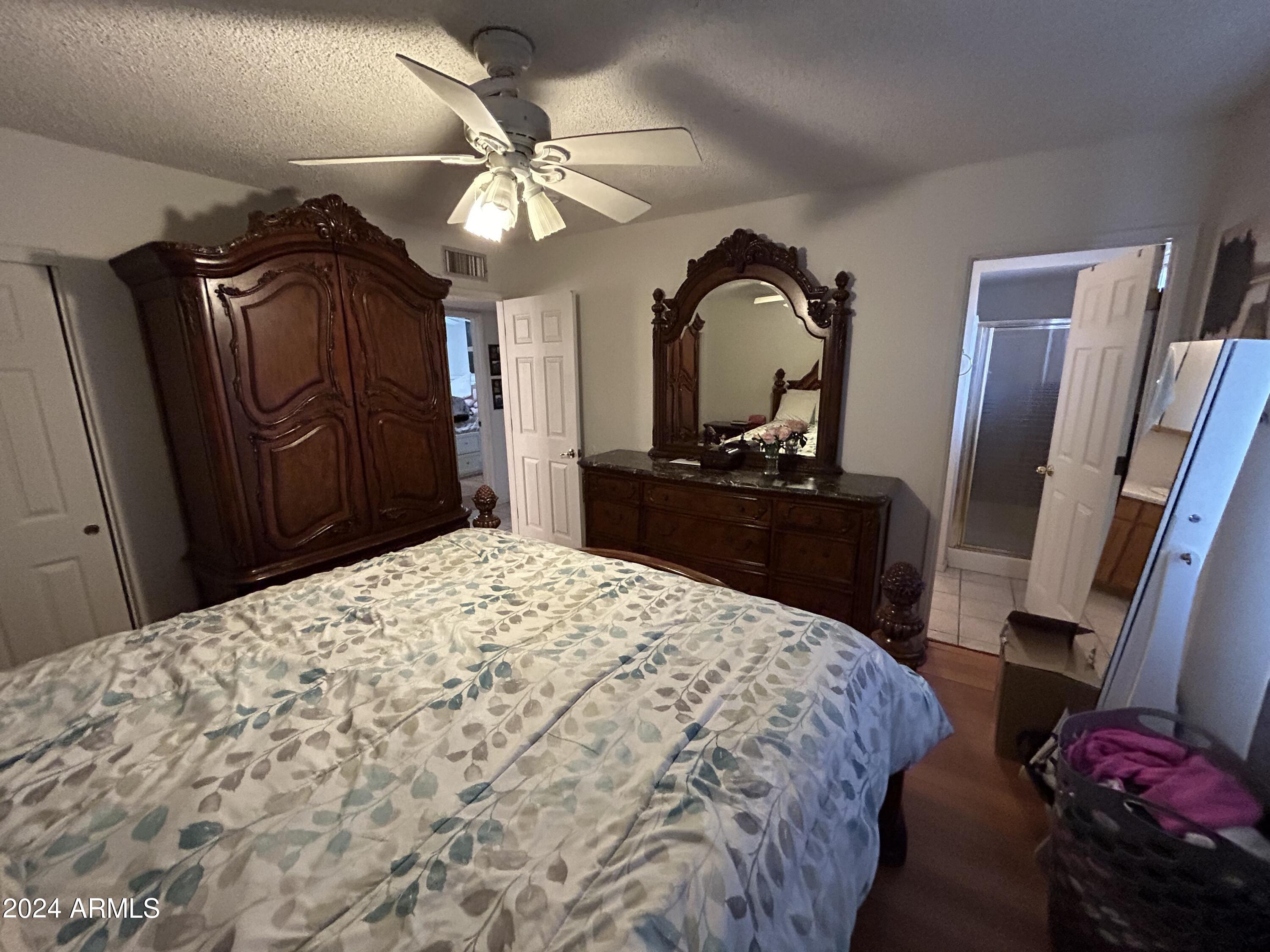 2419 East 10th Street Douglas, AZ 85607 - Photo 18 of 21 a bedroom with a bed and a dresser