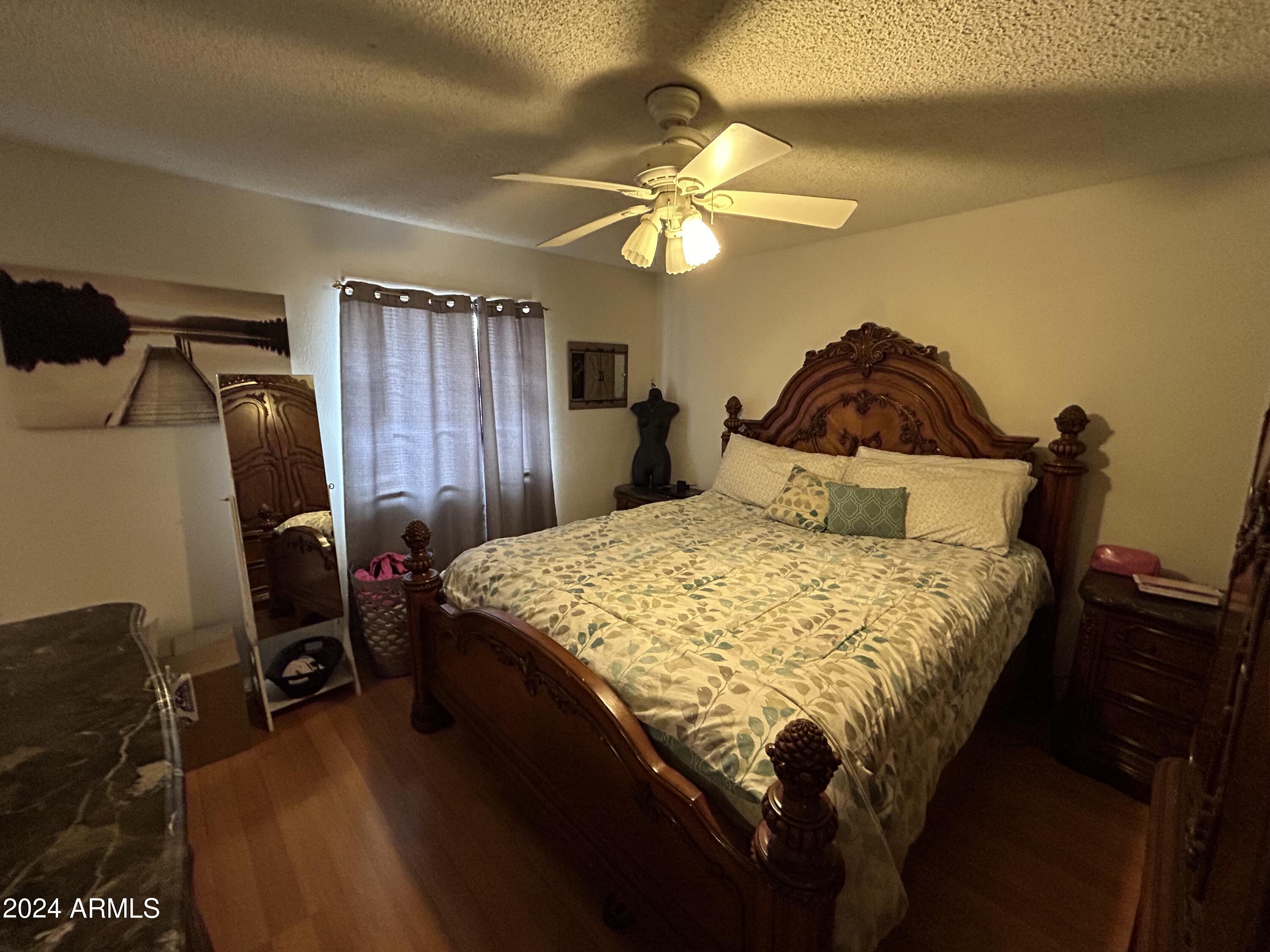 2419 East 10th Street Douglas, AZ 85607 - Photo 19 of 21 a bedroom with a bed and a chandelier