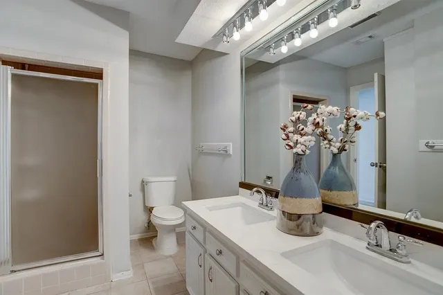 a bathroom with a sink a toilet and a mirror