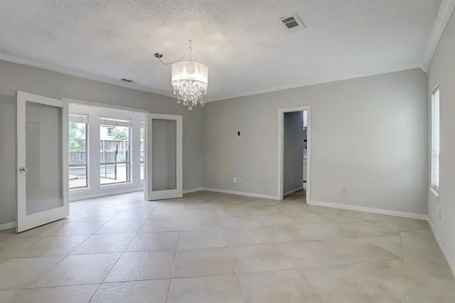 a view of an empty room with a chandelier