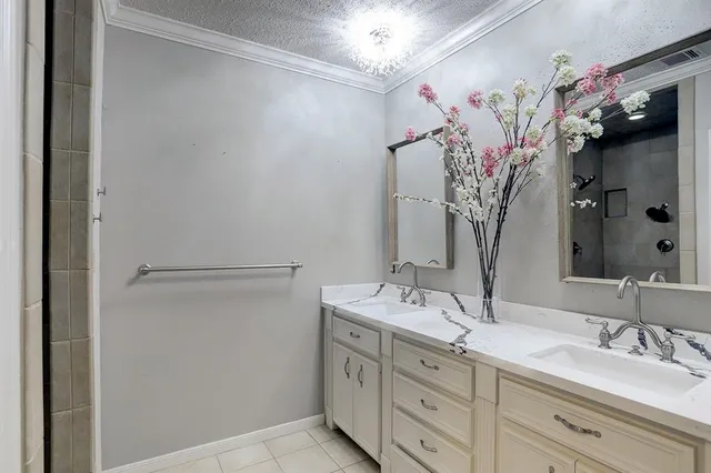 a bathroom with a double vanity sink mirror and cabinets