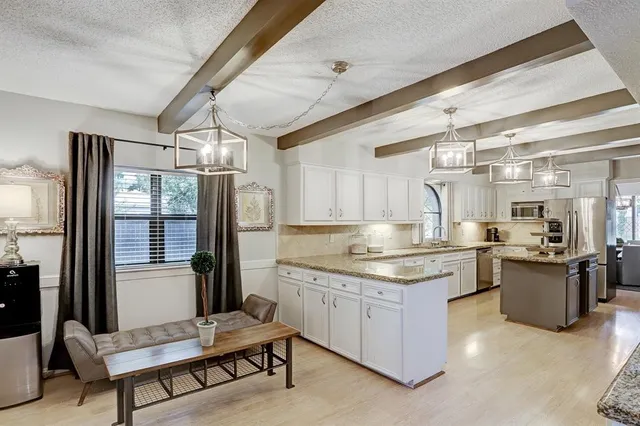 a kitchen with a refrigerator and a stove