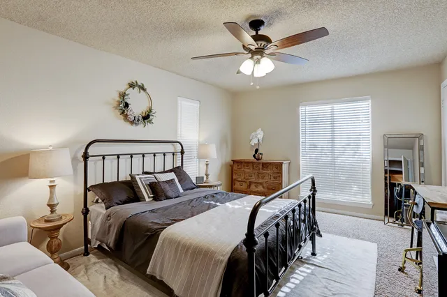 a bedroom with bed and wooden floor