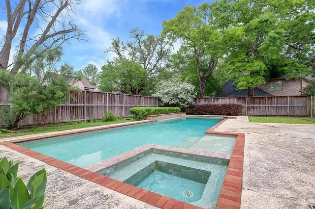 a view of a backyard with swimming pool