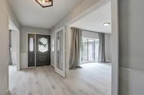 an empty room with windows and closet