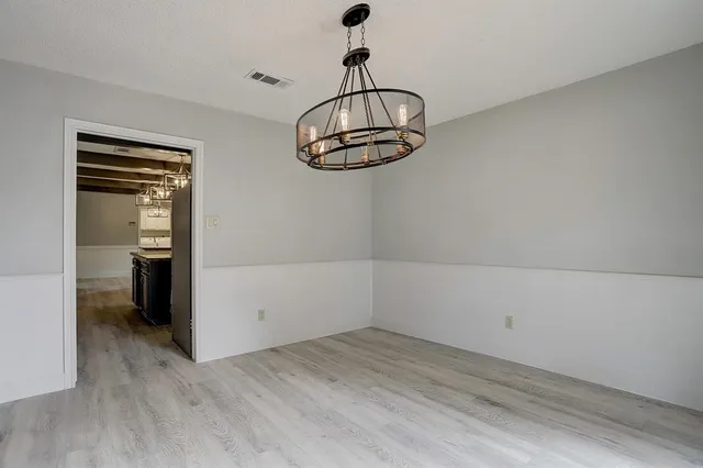 a view of a room with wooden floor and utility room
