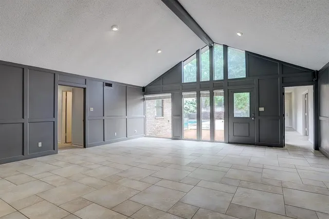 a large room with a large window and chandelier