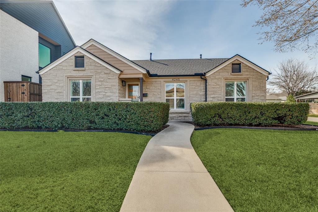 Ranch-style home featuring stone siding, a front yard, and a shingled roof