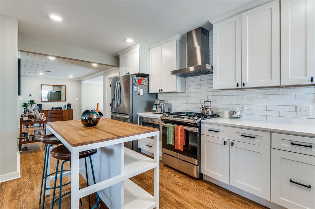 4245 Concho Street Dallas, TX 75206 - Photo 11 of 30 Kitchen featuring stainless steel appliances, white cabinets, light wood-style flooring, and recessed lighting