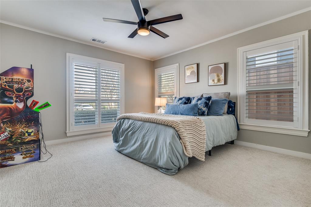 4245 Concho Street Dallas, TX 75206 - Photo 18 of 30 Bedroom with carpet flooring, crown molding, and ceiling fan